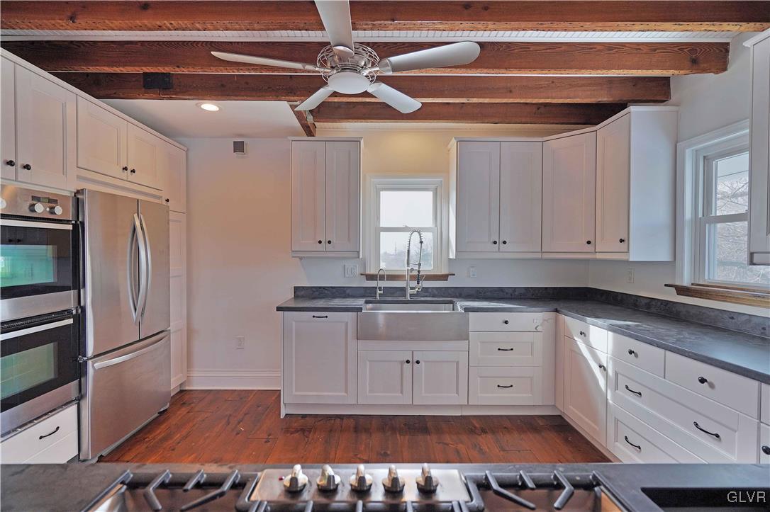 512 Lefevre Road Easton, PA 18040 - Photo 8 of 23 a kitchen with granite countertop a stove and white cabinets