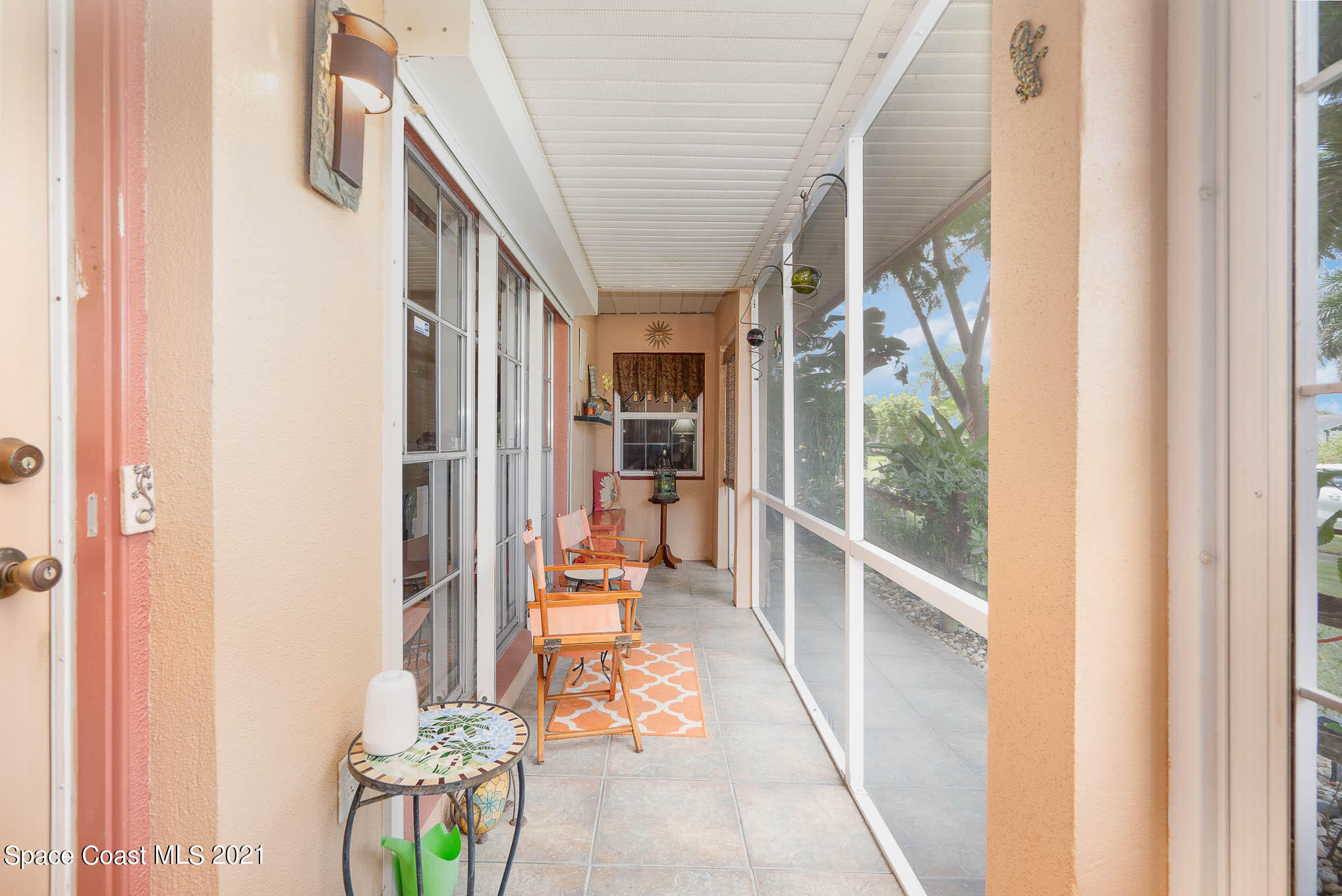 1291 Creel Road Northeast Palm Bay, FL 32905 - Photo 3 of 31 a hallway with a dining table and chairs