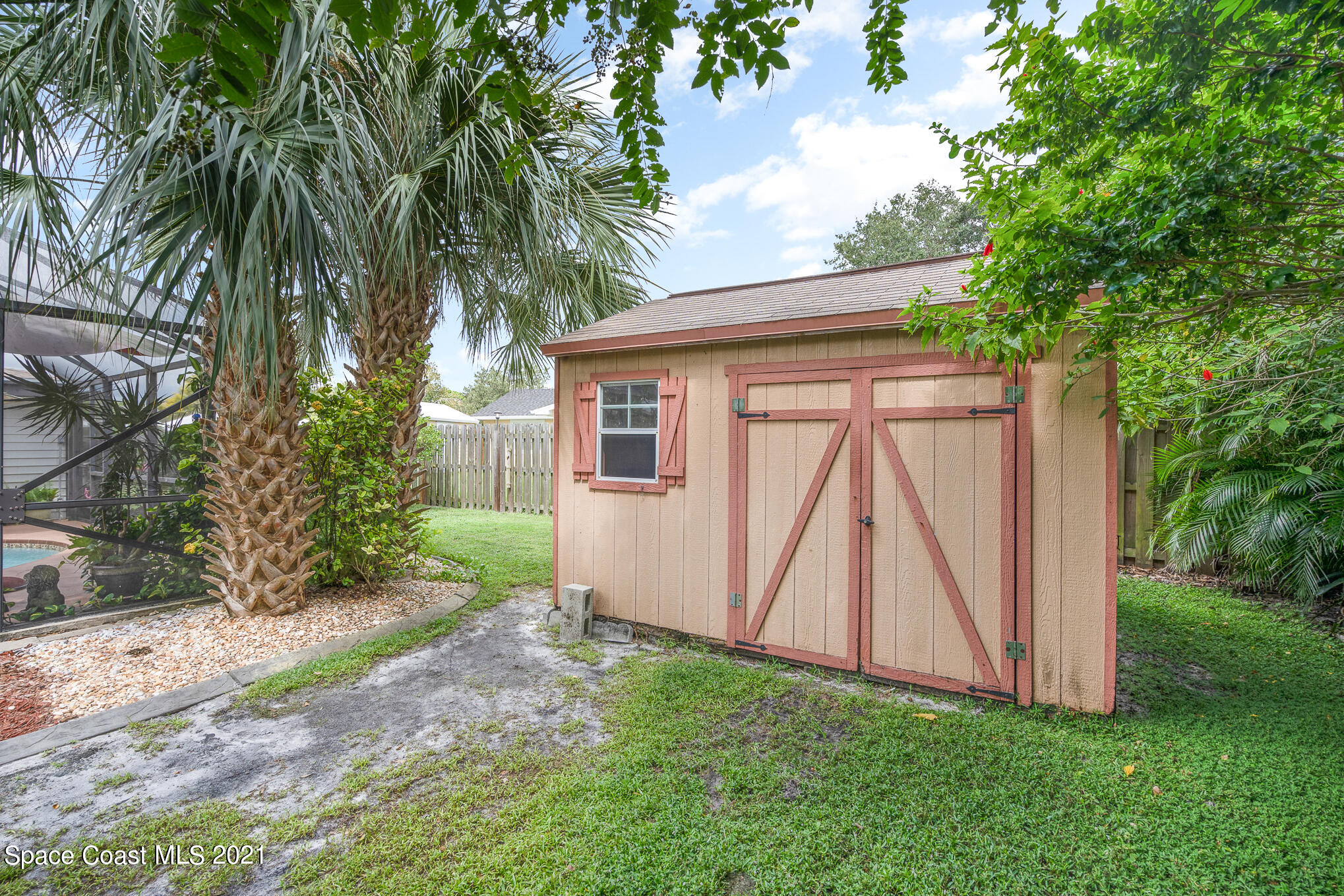 1291 Creel Road Northeast Palm Bay, FL 32905 - Photo 29 of 31 a view of a backyard with a small cabin
