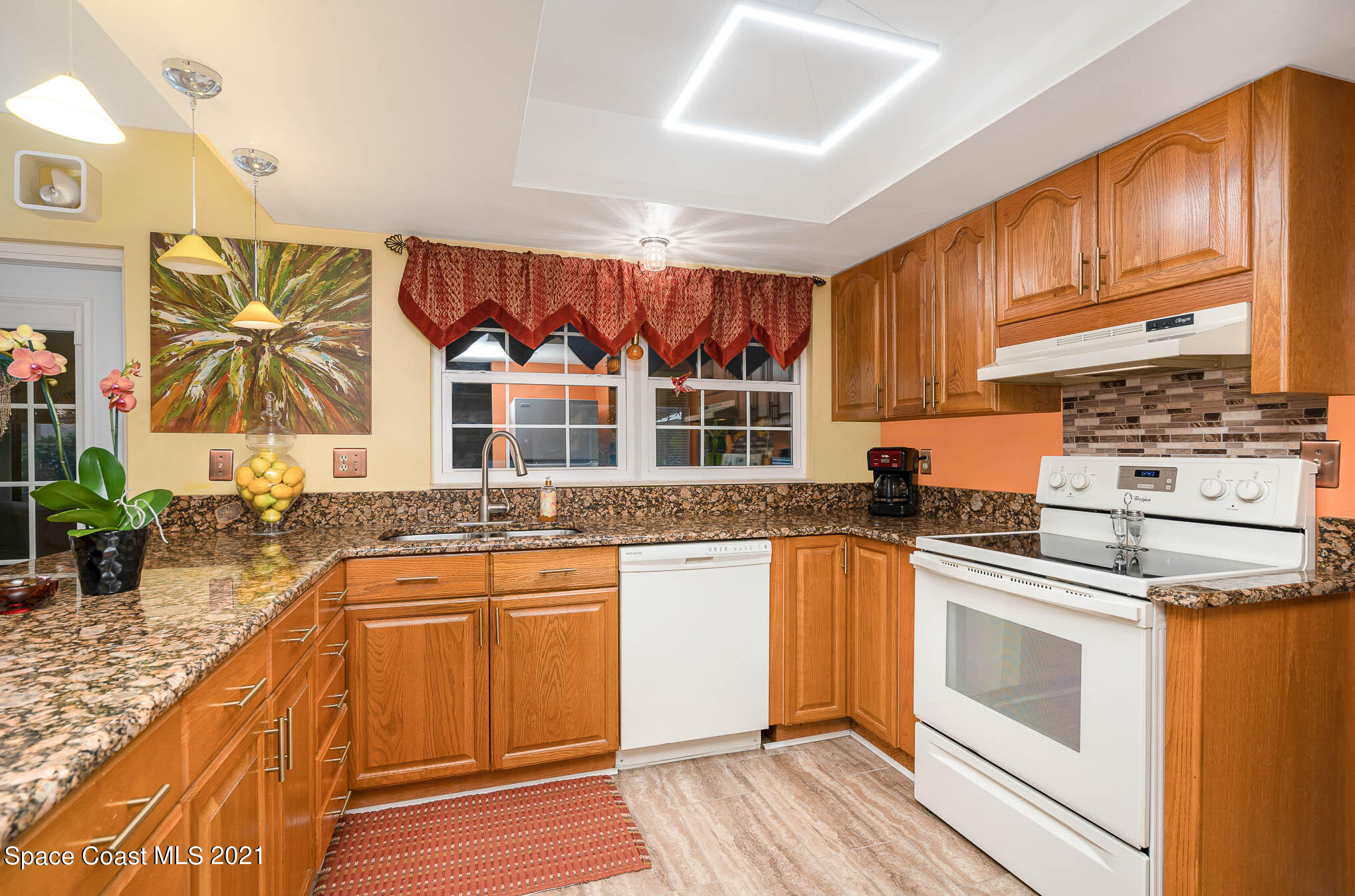 1291 Creel Road Northeast Palm Bay, FL 32905 - Photo 4 of 31 a kitchen with stainless steel appliances granite countertop a stove a sink and a microwave