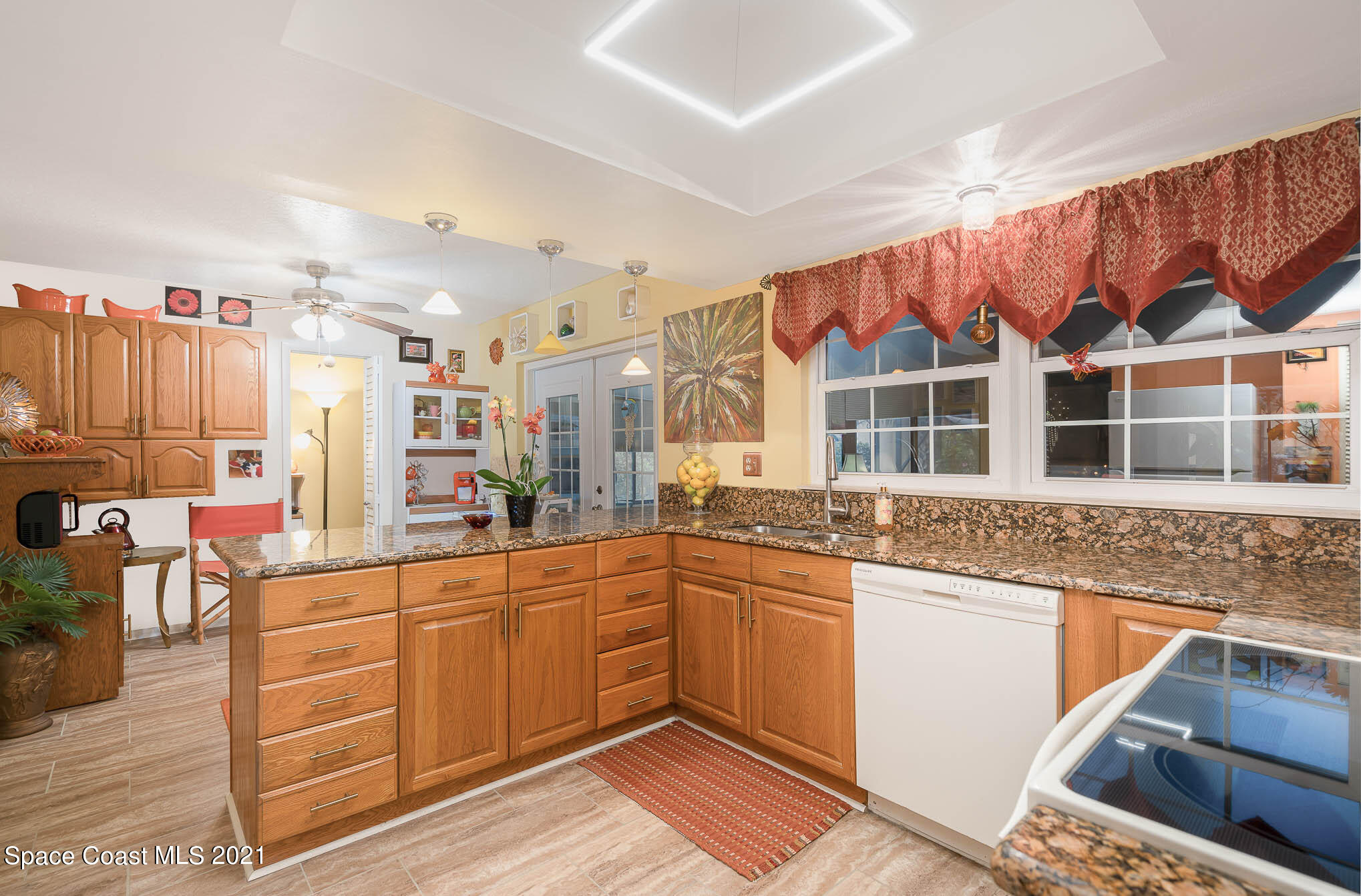 1291 Creel Road Northeast Palm Bay, FL 32905 - Photo 5 of 31 a kitchen with stainless steel appliances granite countertop a sink and cabinets