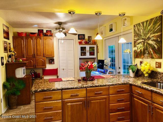 1291 Creel Road Northeast Palm Bay, FL 32905 - Photo 7 of 31 a bathroom with a granite countertop sink and a mirror