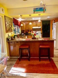 1291 Creel Road Northeast Palm Bay, FL 32905 - Photo 8 of 31 a kitchen with a sink cabinets and stove top oven