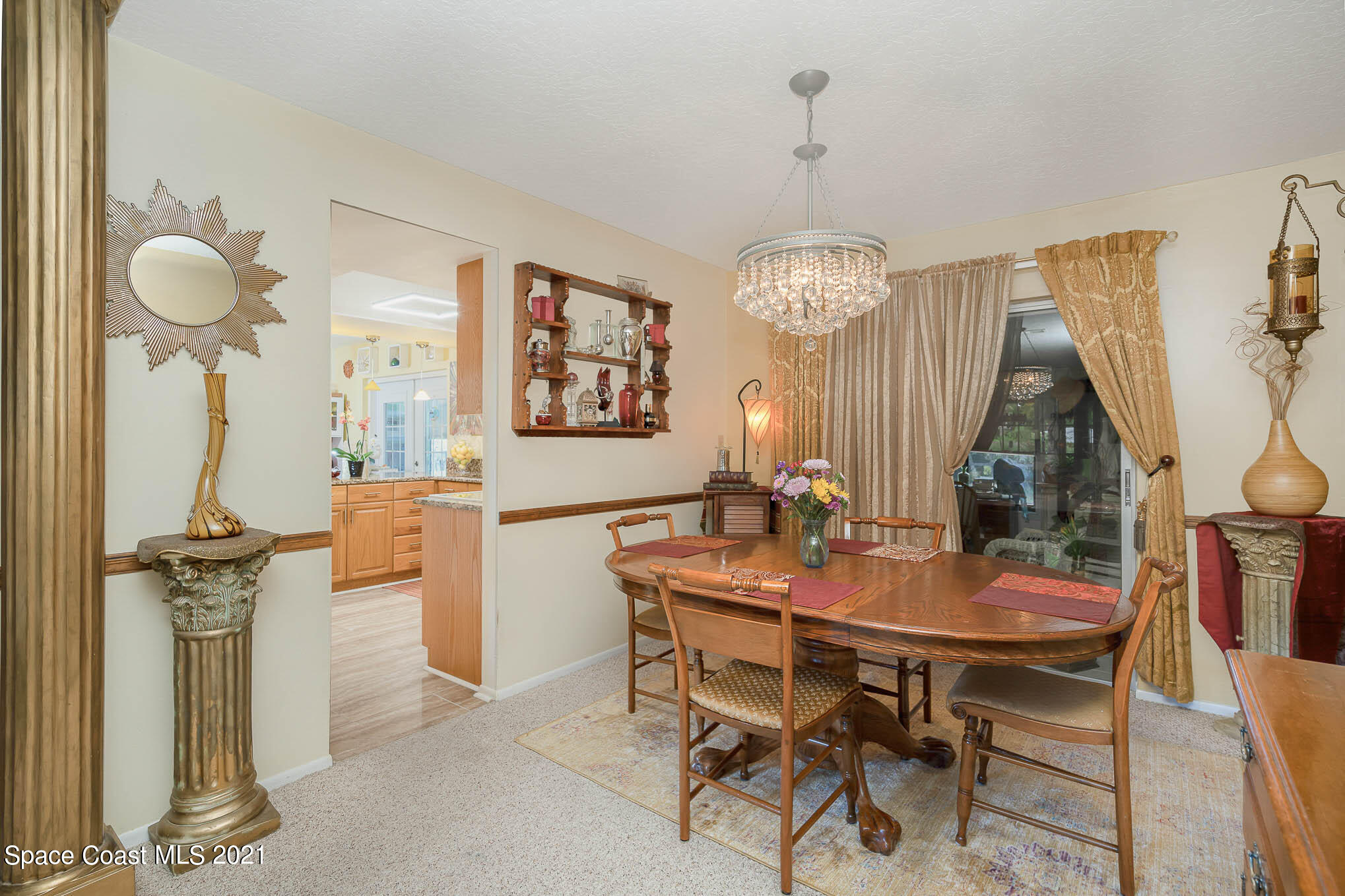 1291 Creel Road Northeast Palm Bay, FL 32905 - Photo 10 of 31 a view of a dining room with furniture and a chandelier