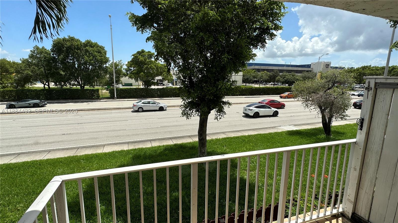 a view of street from deck with patio