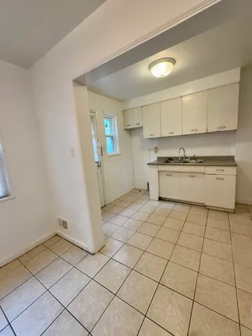a kitchen with a stove a sink and a refrigerator