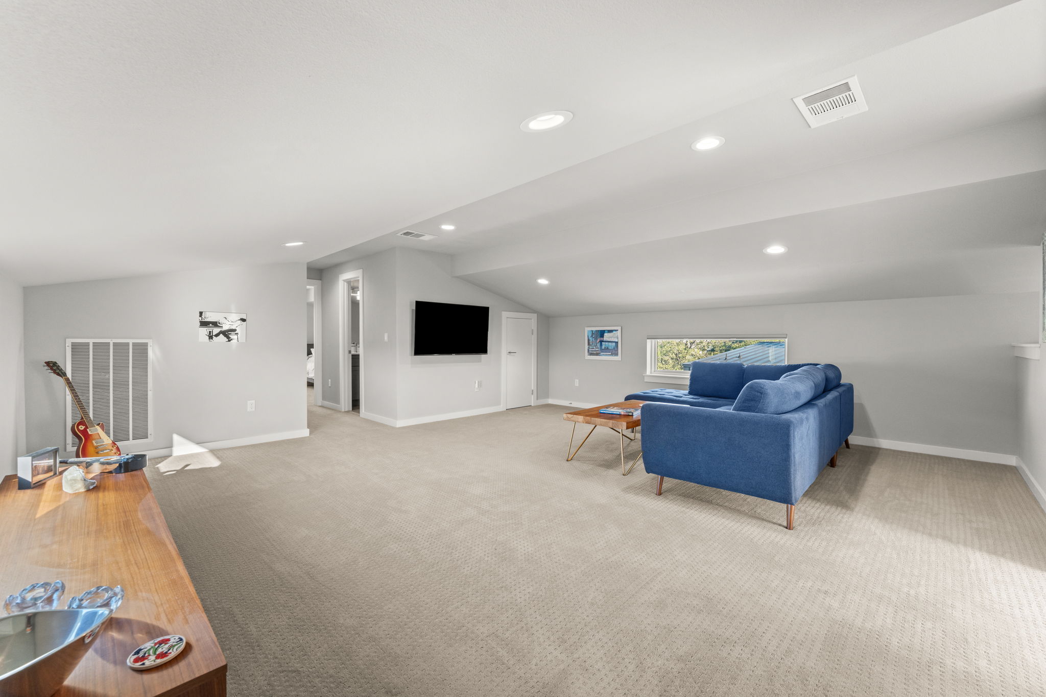 1116 Stobaugh Street, Unit A Austin, TX 78757 - Photo 27 of 37 a living room with furniture and a flat screen tv
