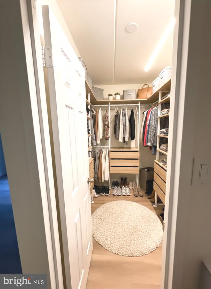 2316 Freetown Court, Unit 1B Reston, VA 20191 - Photo 30 of 36 a view of walk in closet with clothes and shoes