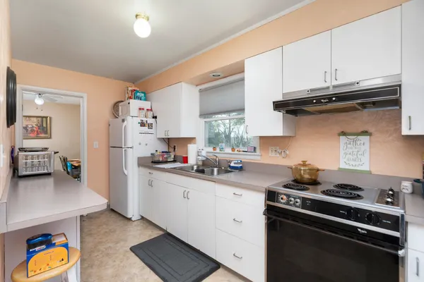 a kitchen with stainless steel appliances granite countertop a stove and a sink
