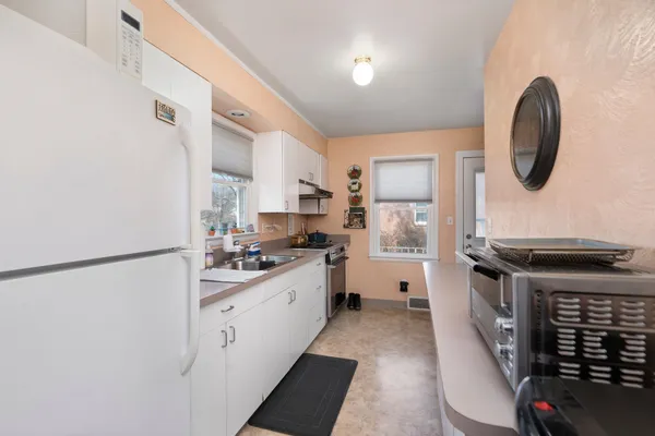 a kitchen with stainless steel appliances a stove a sink and a refrigerator
