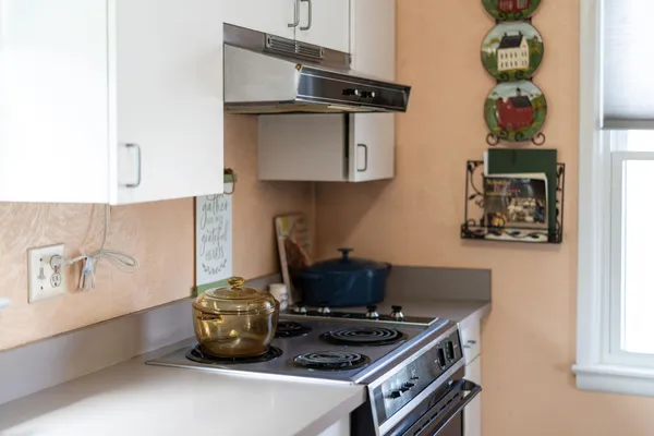 a kitchen with stainless steel appliances granite countertop a stove and a microwave