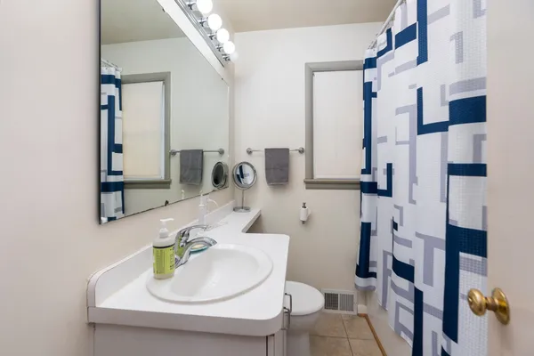 a bathroom with a sink toilet and shower