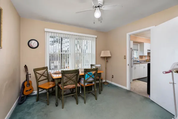 a dining room with furniture and window