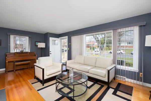 a living room with furniture and a table with wooden floor