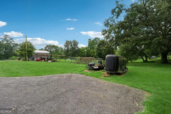 a view of backyard with slide and bench