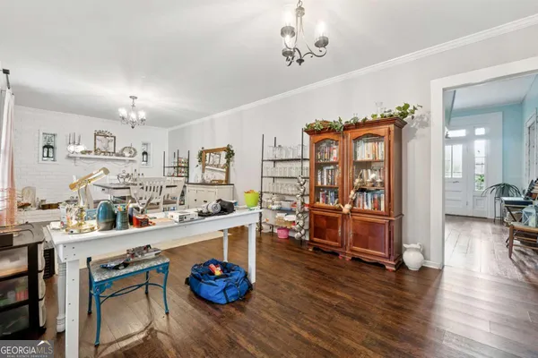 a kitchen with stainless steel appliances granite countertop a sink dishwasher stove and white cabinets with wooden floor
