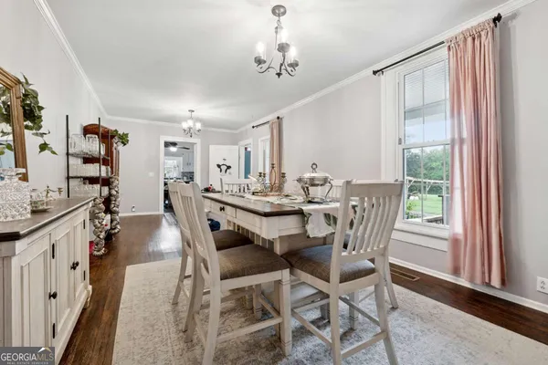 a dining room with furniture and window
