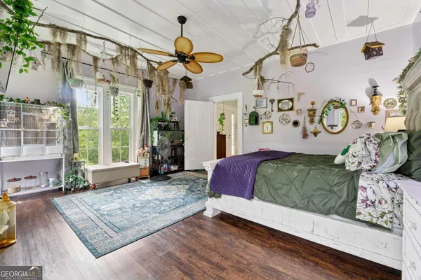 a bedroom with a bed and dresser with window