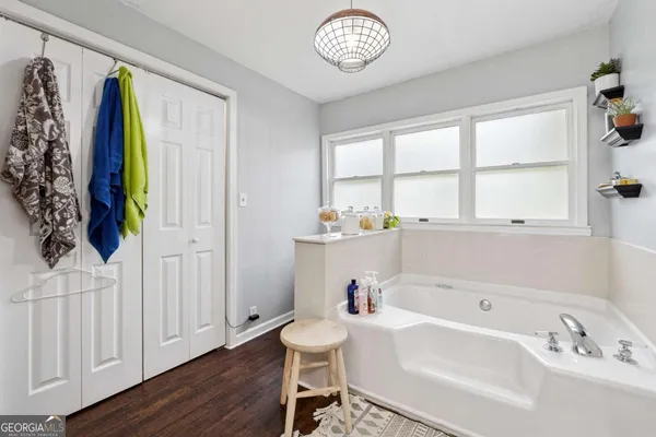 a bathroom with a bathtub a sink and a window
