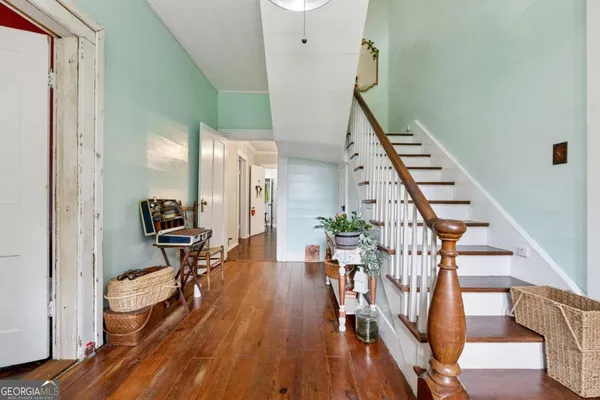 a view of an entryway with wooden floor and stairs