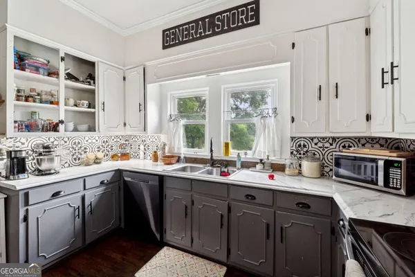 a kitchen with a sink cabinets and window