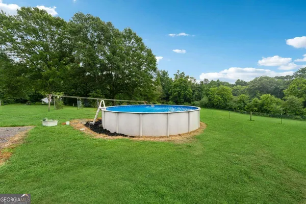 a view of a swimming pool with a yard