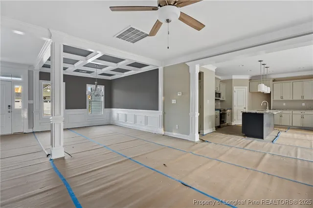 a view of a hall with wooden floor and a ceiling fan
