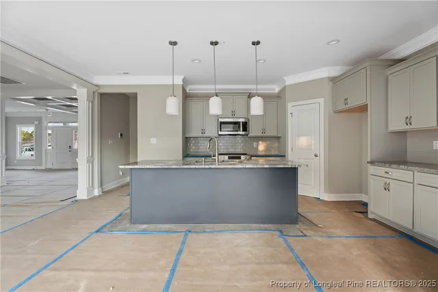 a view of kitchen with stainless steel appliances granite countertop cabinets and a counter top space