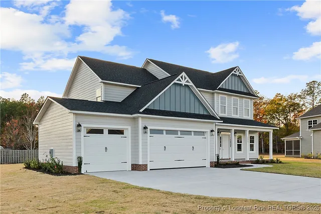 a view of a white house with a large space in front of it