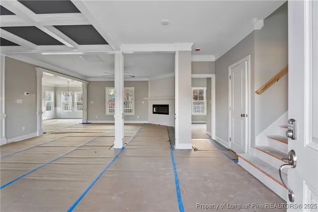 a view of a hallway with wooden floors and cabinet