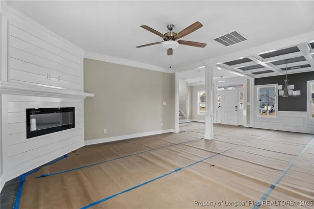 a view of a livingroom with a ceiling fan and window