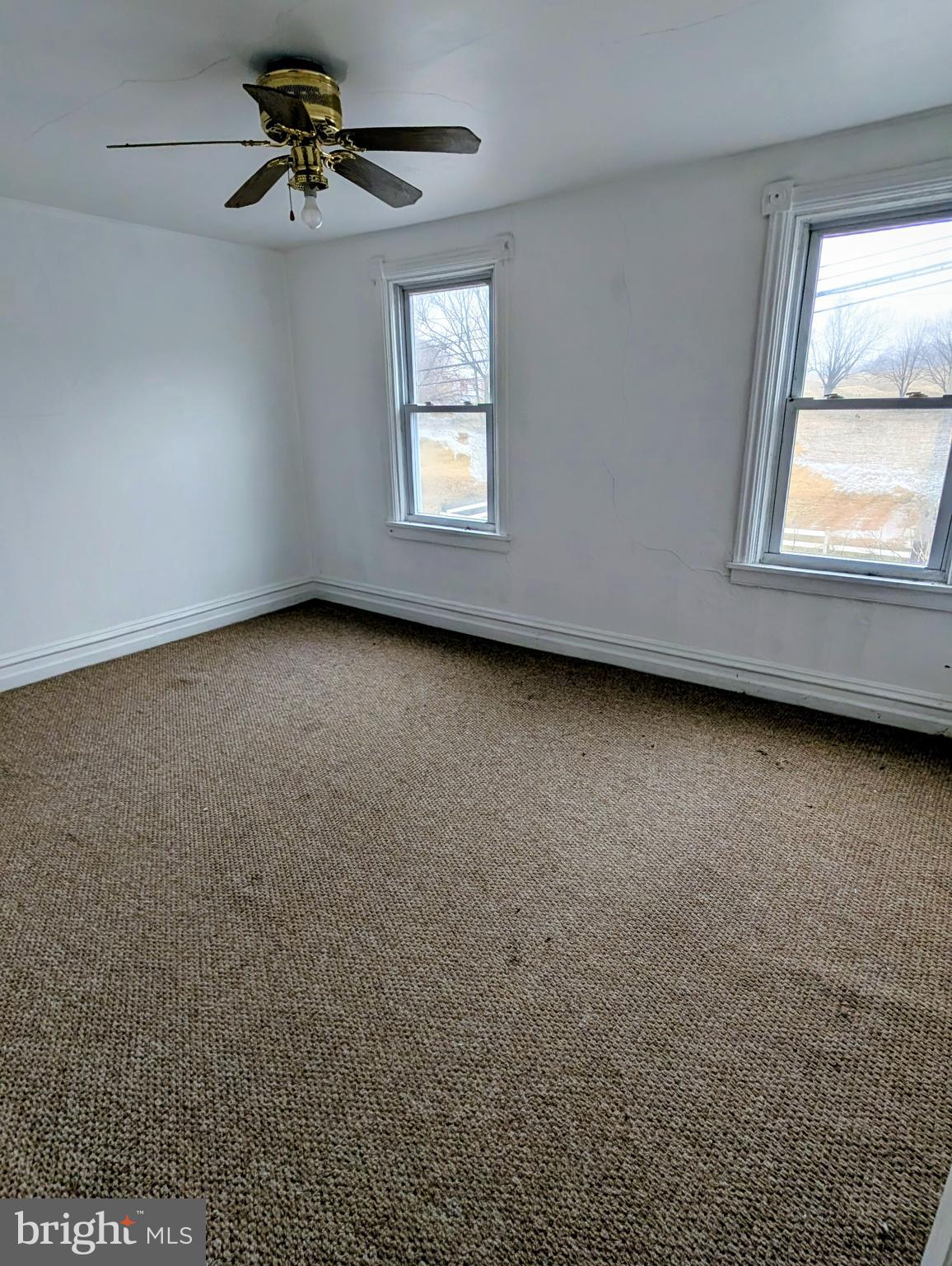 1988 Valley Road Parkesburg, PA 19365 - Photo 7 of 14 an empty room with windows and fan
