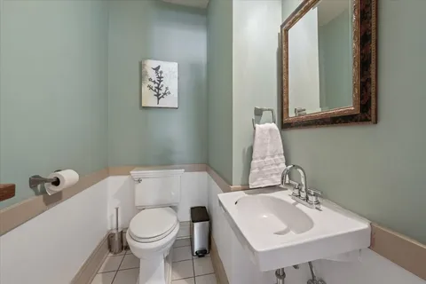 a bathroom with a sink toilet and mirror