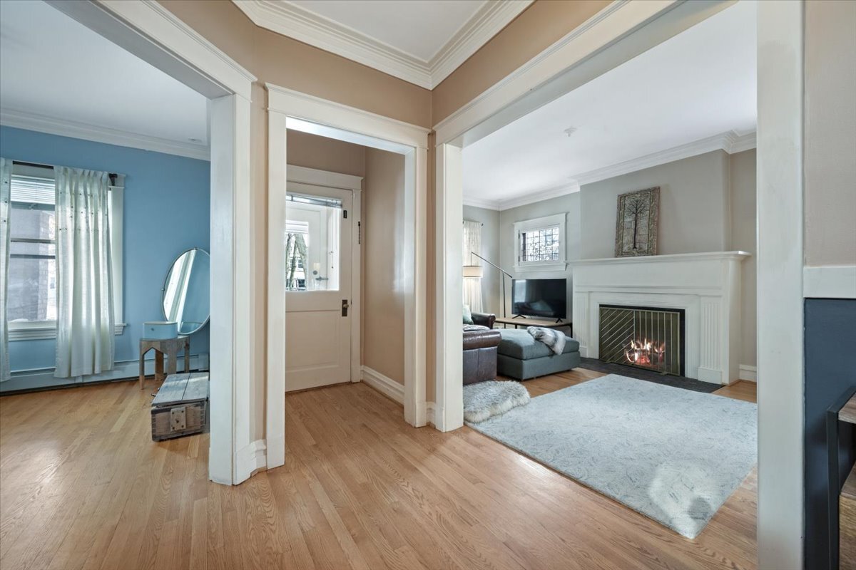 233 South Ridgeland Avenue Oak Park, IL 60302 - Photo 5 of 20 a view of a livingroom with wooden floor and a fireplace