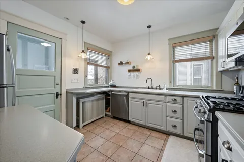 a kitchen with a sink stove and cabinets