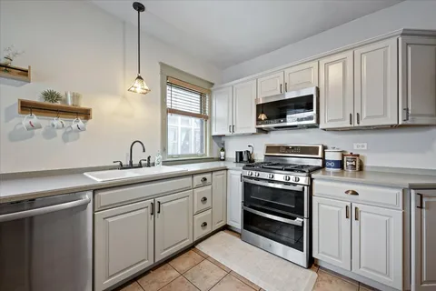 a kitchen with appliances cabinets and a sink