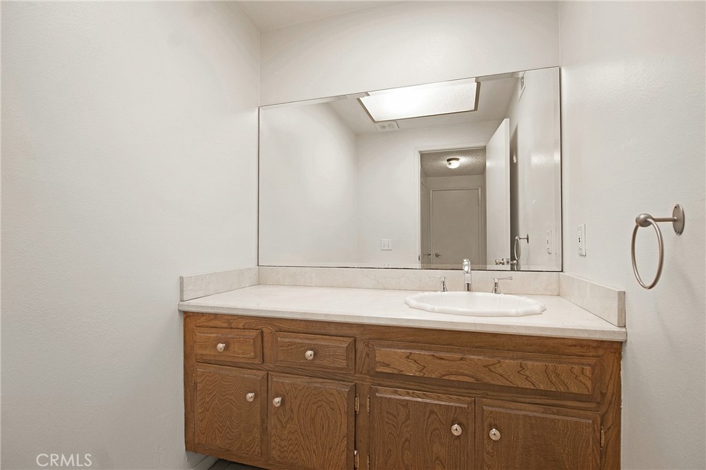 3808 Mistral Drive Huntington Beach, CA 92649 - Photo 13 of 28 a bathroom with a sink vanity and mirror