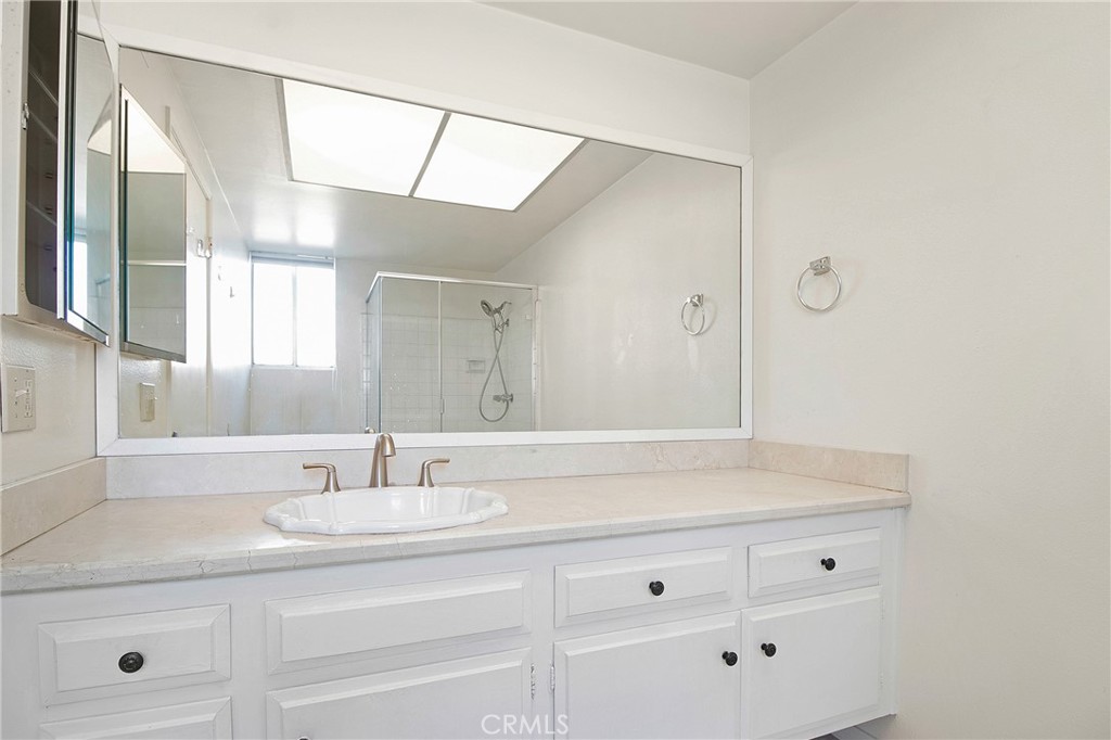 3808 Mistral Drive Huntington Beach, CA 92649 - Photo 16 of 28 a bathroom with a sink and a mirror