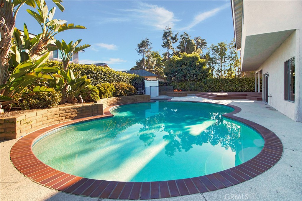 3808 Mistral Drive Huntington Beach, CA 92649 - Photo 2 of 28 a view of a swimming pool with a yard