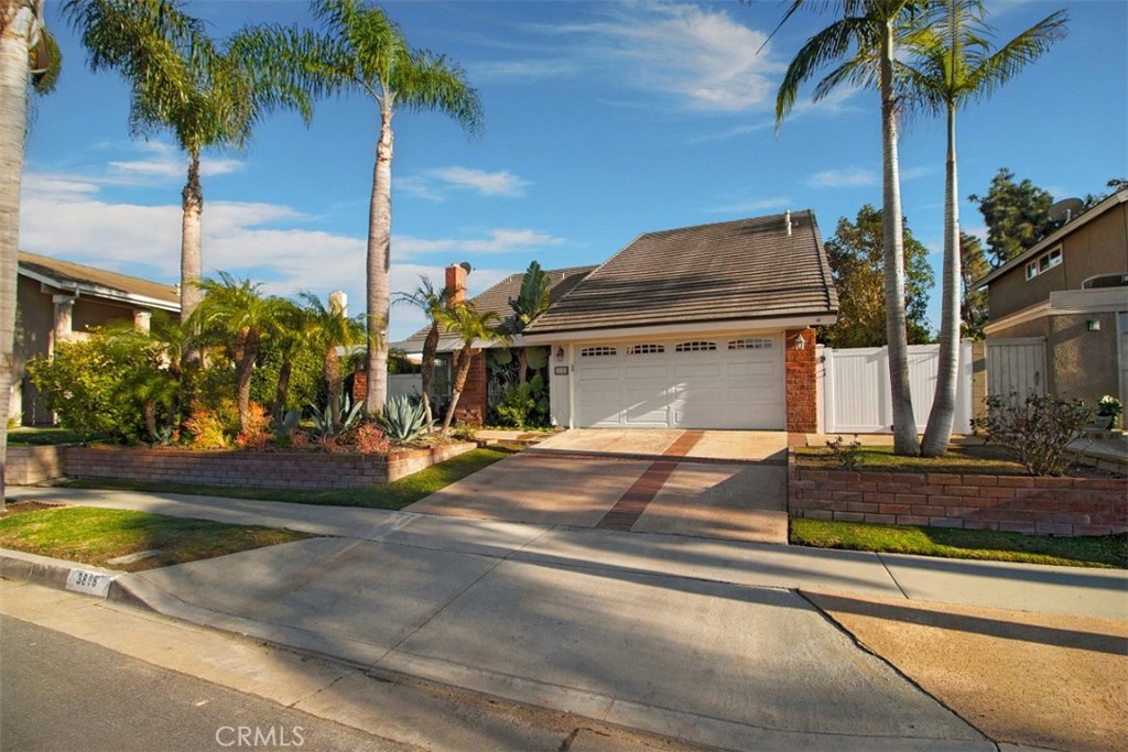 3808 Mistral Drive Huntington Beach, CA 92649 - Photo 27 of 28 a view of a house with a yard and palm trees