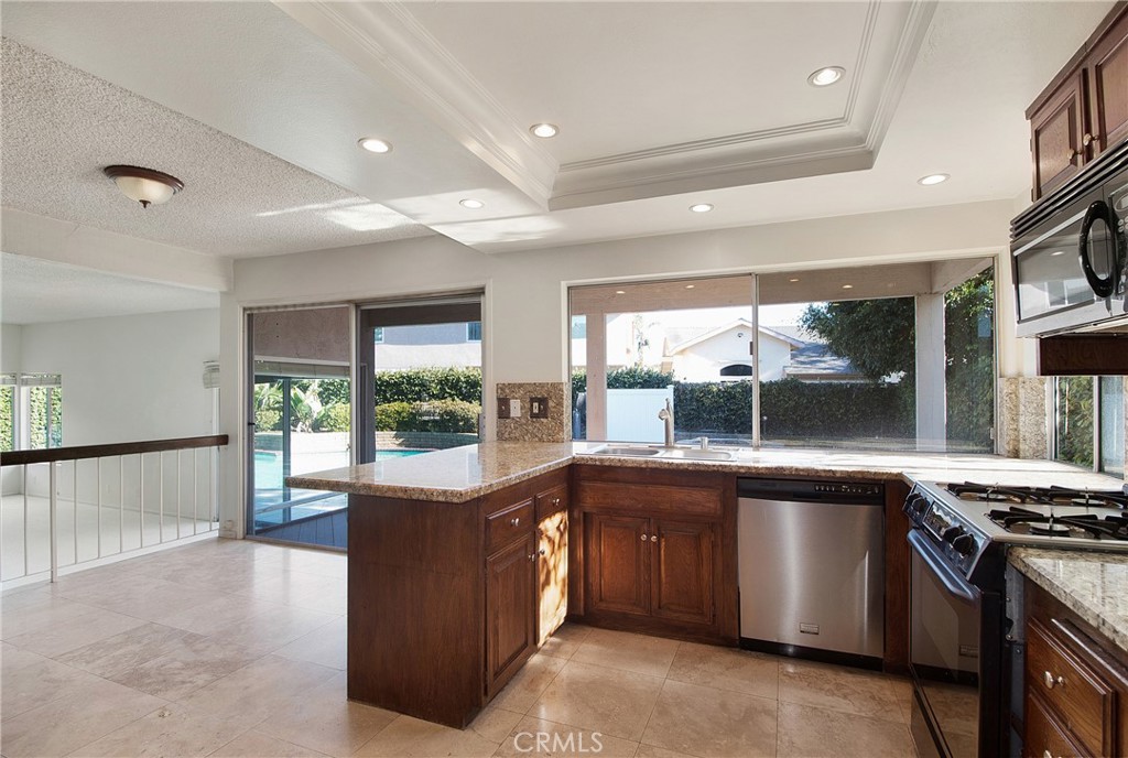3808 Mistral Drive Huntington Beach, CA 92649 - Photo 4 of 28 a large kitchen with stainless steel appliances granite countertop a stove and a large window