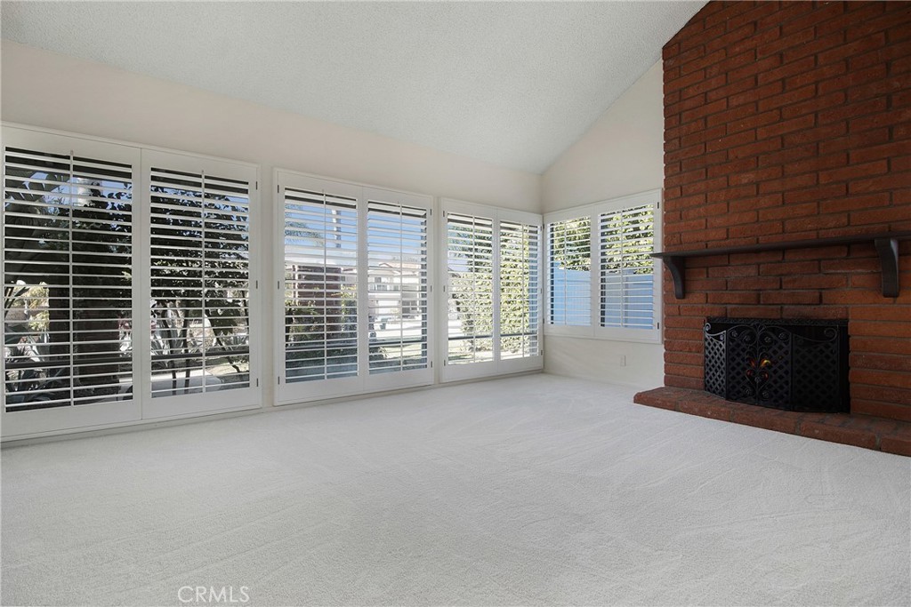 3808 Mistral Drive Huntington Beach, CA 92649 - Photo 10 of 28 a view of an empty room with a fireplace and a window