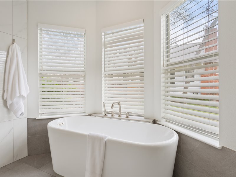 1205 South Main Street Georgetown, TX 78626 - Photo 18 of 35 a bathroom with a bathtub and next to a window