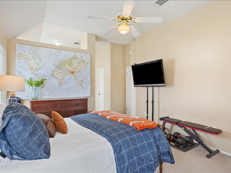 1205 South Main Street Georgetown, TX 78626 - Photo 22 of 35 a bedroom with a bed and a flat screen tv