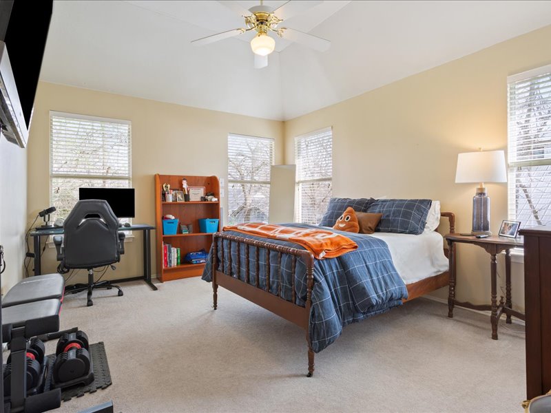 1205 South Main Street Georgetown, TX 78626 - Photo 23 of 35 a bedroom with a bed and a chandelier