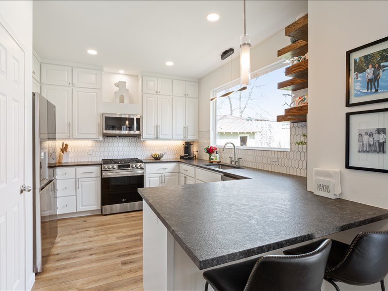1205 South Main Street Georgetown, TX 78626 - Photo 6 of 35 a kitchen with stainless steel appliances granite countertop a sink a stove and a refrigerator