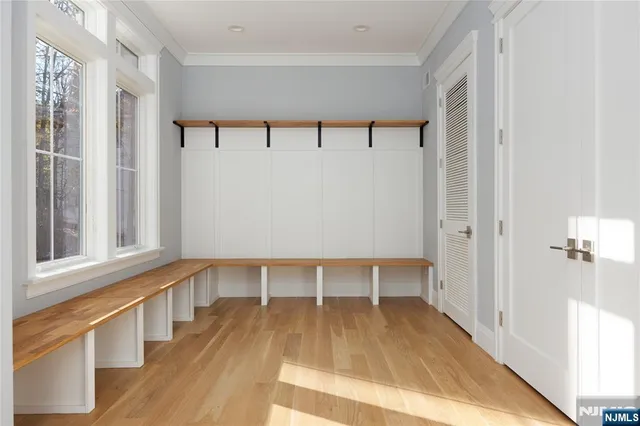 a view of a room with wooden floor and a window
