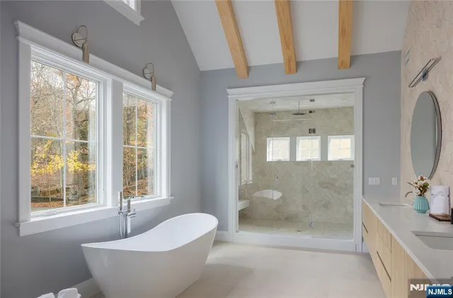 a bathroom with a bathtub and shower