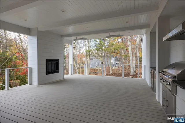 a view of an empty room with a window and a kitchen