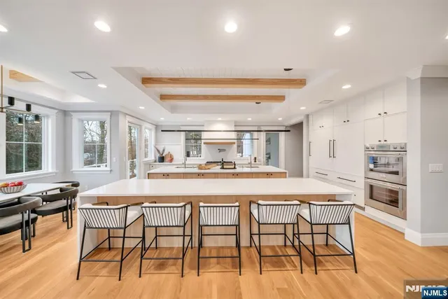 a bedroom with a bed and large windows
